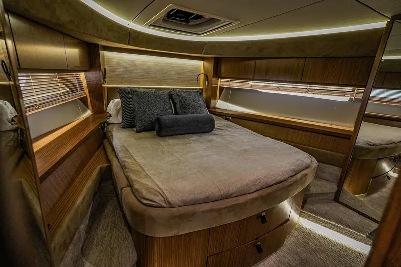 Yan Ge Yacht Photos Pics Luxurious cabin interior of 2018 Sea Ray L590 Fly yacht with cozy bed and elegant wood finish.