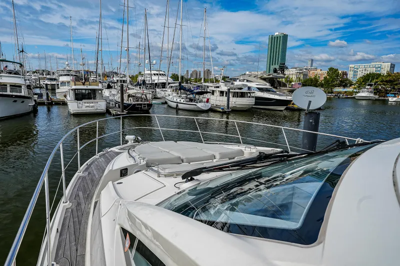 Yan Ge Yacht Photos Pics 2018 Sea Ray L590 Fly yacht docked in a marina with other boats.