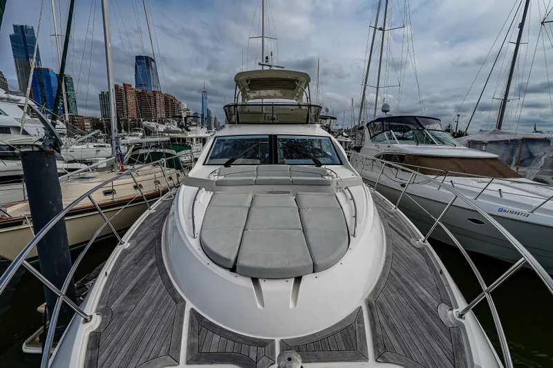 Yan Ge Yacht Photos Pics 2018 Sea Ray L590 Fly yacht docked in a marina with city skyline backdrop.