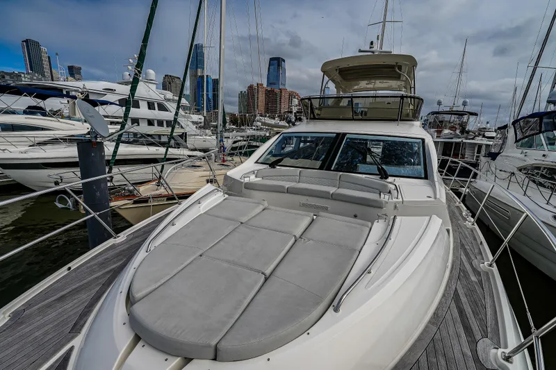Yan Ge Yacht Photos Pics 2018 Sea Ray L590 Fly yacht docked in a marina with city skyline backdrop.