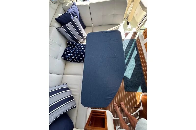 Luna Yacht Photos Pics Cozy seating area on 2020 Back Cove 37 yacht with nautical-themed cushions.