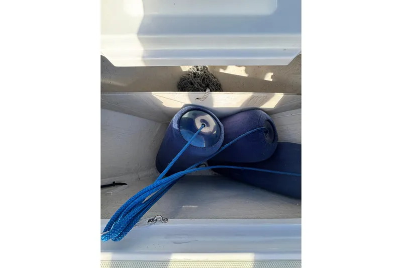 Luna Yacht Photos Pics Storage compartment on a 2020 Back Cove 37 boat with blue fenders and rope.