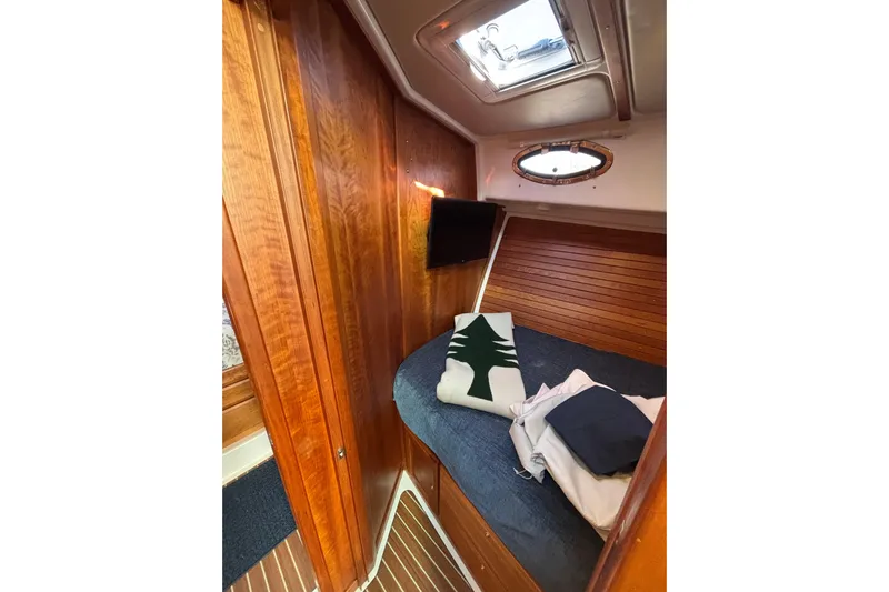 Luna Yacht Photos Pics Cozy cabin interior of 2020 Back Cove 37 yacht with wood paneling and bedding.
