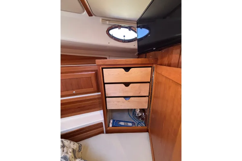 Luna Yacht Photos Pics Interior of 2020 Back Cove 37 yacht with wooden drawers and porthole window.