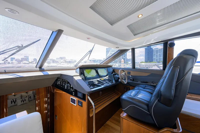 Haute Vie Yacht Photos Pics Luxurious 2020 Princess V60 yacht cockpit with modern navigation system and leather seating.