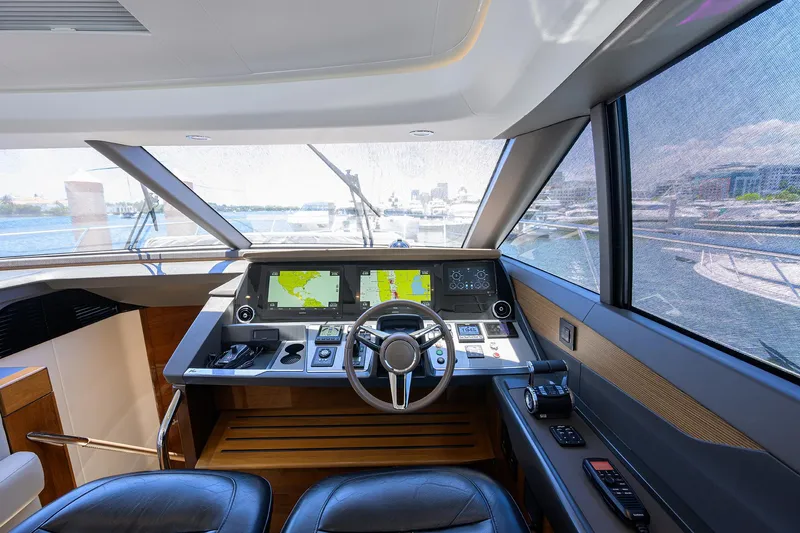 Haute Vie Yacht Photos Pics Interior helm of 2020 Princess V60 yacht with navigation screens and steering wheel.