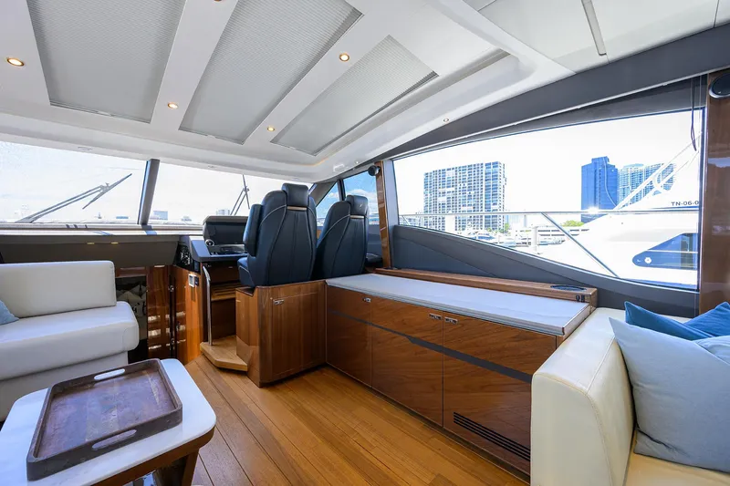 Haute Vie Yacht Photos Pics Luxurious interior of a 2020 Princess V60 yacht with modern seating and cityscape view.