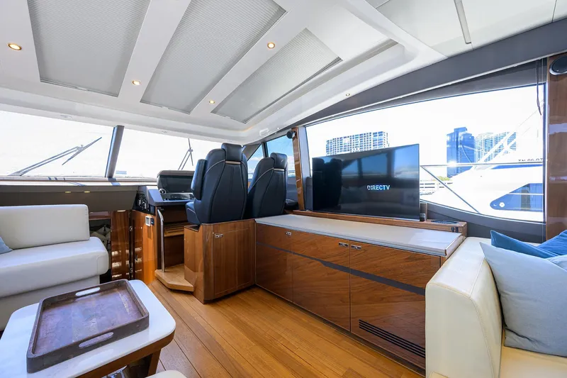 Haute Vie Yacht Photos Pics Luxurious interior of 2020 Princess V60 yacht with modern seating and entertainment system.