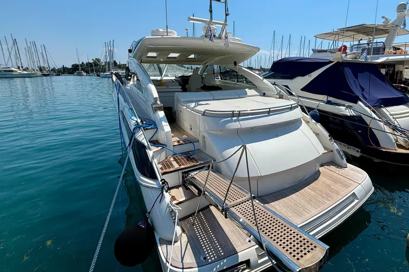  Yacht Photos Pics 2006 Princess V53 yacht docked in marina, featuring sleek design and spacious deck.