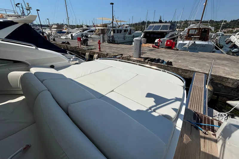  Yacht Photos Pics Luxury yacht Princess V53, 2006 model, docked at marina with sunbathing area.