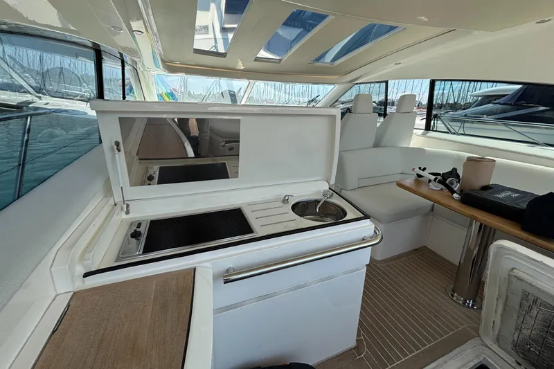  Yacht Photos Pics Interior of 2006 Princess V53 yacht with kitchenette and seating area.