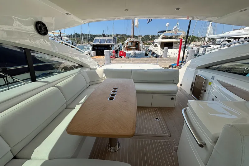  Yacht Photos Pics Luxurious 2006 Princess V53 yacht interior with elegant seating and wooden table at marina.
