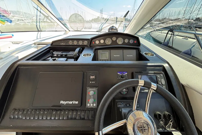  Yacht Photos Pics Helm of 2006 Princess V53 yacht with Raymarine navigation system and steering wheel.