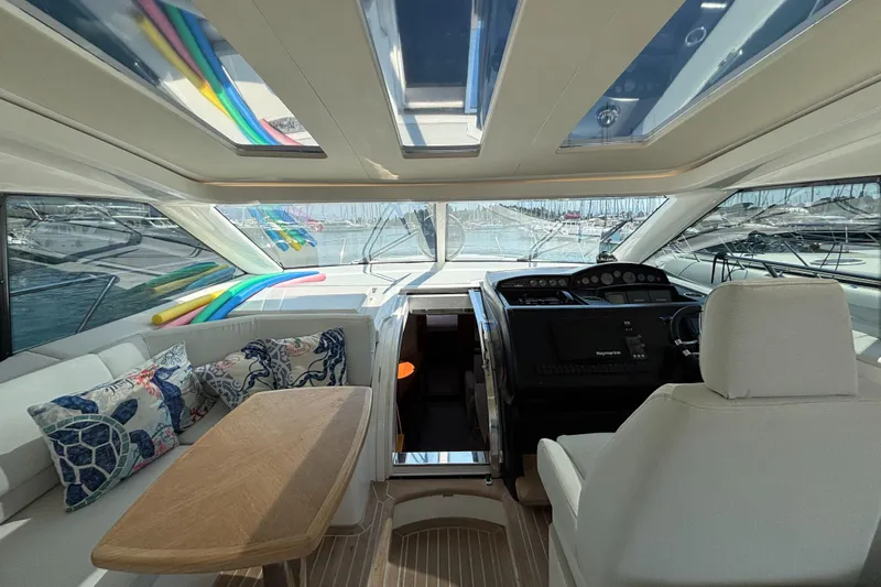  Yacht Photos Pics Luxurious interior of a 2006 Princess V53 yacht with helm, seating, and decorative pillows.