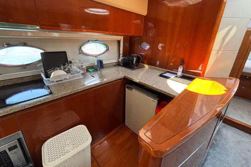  Yacht Photos Pics Luxurious 2006 Princess V53 yacht kitchen with wood cabinetry and modern appliances.