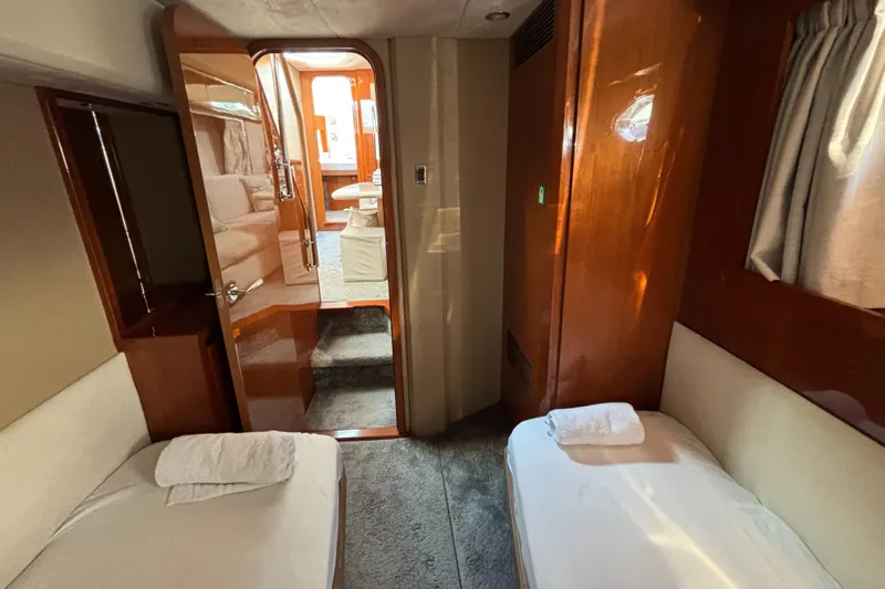  Yacht Photos Pics Interior of 2006 Princess V53 yacht with twin beds and wooden finishes.