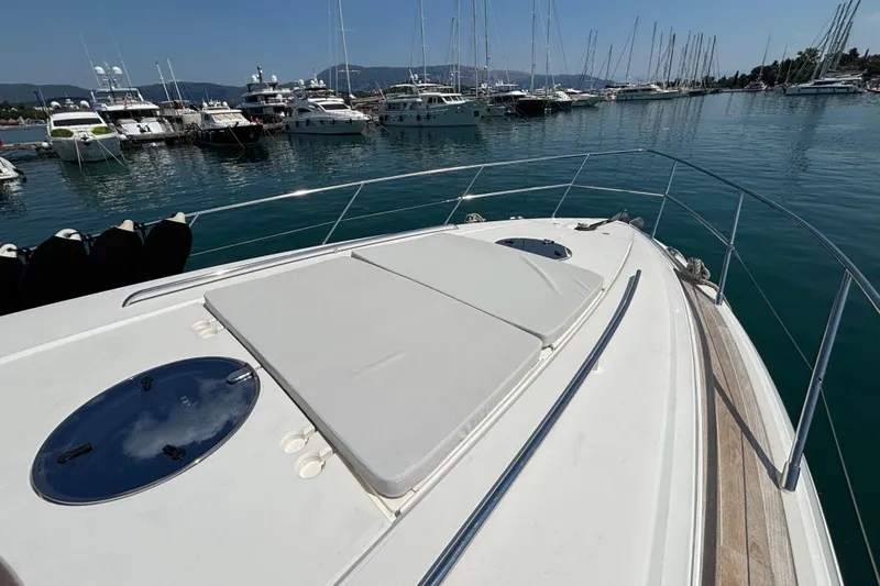  Yacht Photos Pics 2006 Princess V53 yacht docked in a marina with other boats.