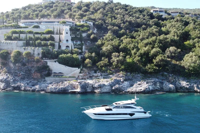  Yacht Photos Pics Luxury yacht Princess V53 cruising near scenic coastal cliffs, 2006 model.