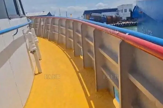  Yacht Photos Pics Yellow deck of a custom 2009 boat with colorful railings, dockside view.