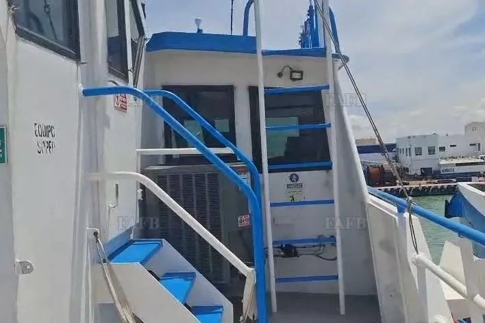  Yacht Photos Pics Custom 2009 boat with blue railings and steps, docked at a harbor.