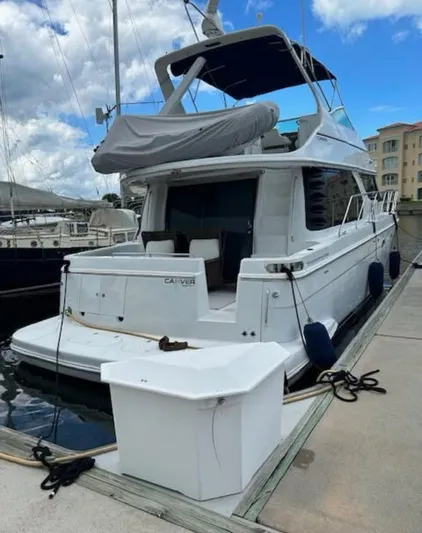  Yacht Photos Pics 2000 Carver 450 Voyager Pilothouse yacht docked at marina under cloudy sky.