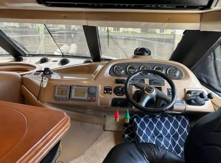  Yacht Photos Pics Interior of 2000 Carver 450 Voyager Pilothouse with steering wheel and navigation instruments.