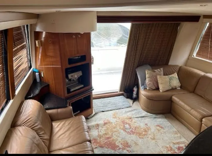  Yacht Photos Pics Luxurious interior of 2000 Carver 450 Voyager Pilothouse with leather seating and wood accents.