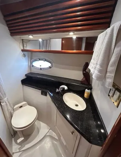  Yacht Photos Pics 2000 Carver 450 Voyager Pilothouse bathroom with black countertop and modern fixtures.