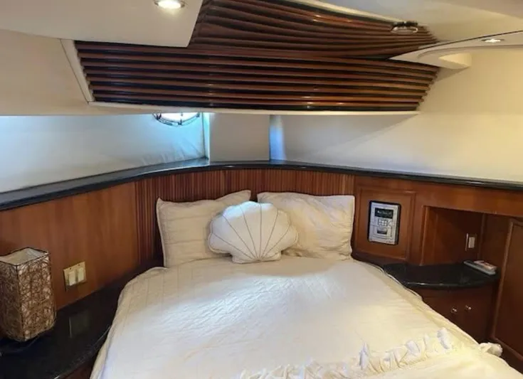  Yacht Photos Pics Luxurious bedroom interior of 2000 Carver 450 Voyager Pilothouse yacht with elegant wood accents.