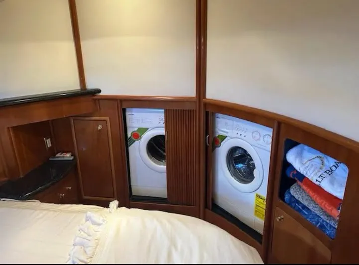  Yacht Photos Pics Laundry area in 2000 Carver 450 Voyager Pilothouse with washer, dryer, and storage.