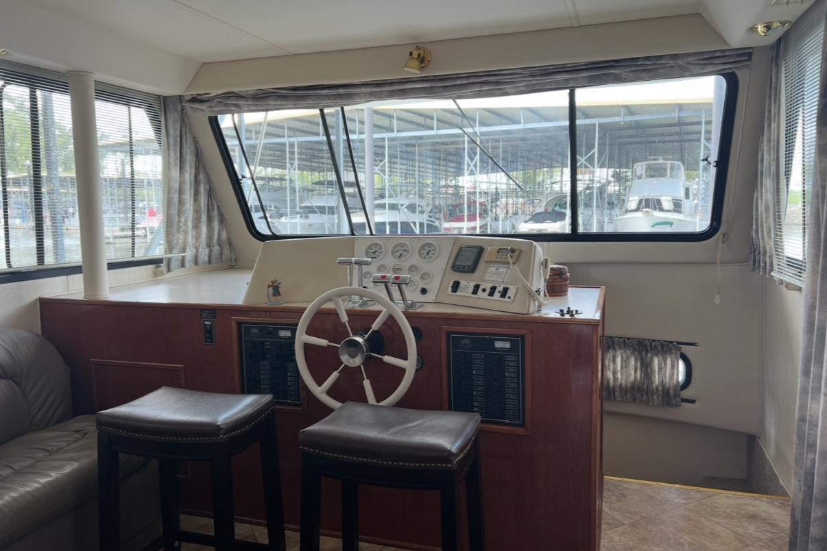 Interior of 2002 Harbor Master 440 Widebody yacht with helm and seating area.