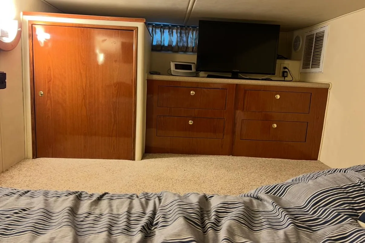 Interior of 2002 Harbor Master 440 Widebody with wood cabinetry and TV.