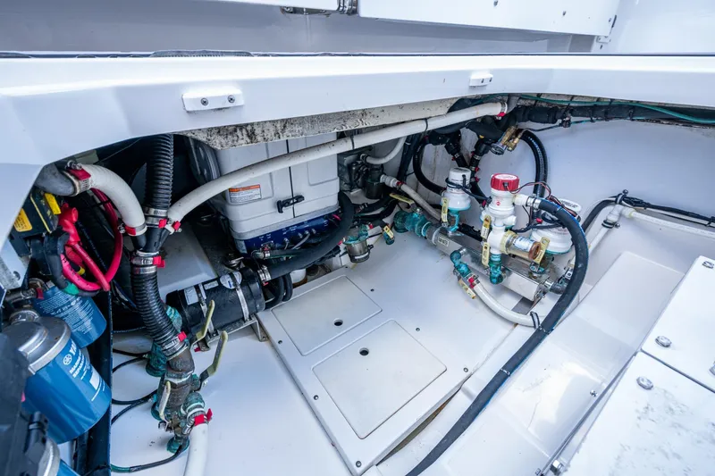  Yacht Photos Pics Engine compartment of 2020 Everglades 395 Center Console boat, showcasing complex wiring and plumbing.