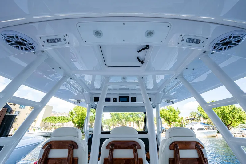  Yacht Photos Pics Interior view of 2020 Everglades 395 Center Console boat, showcasing seating and roof design.