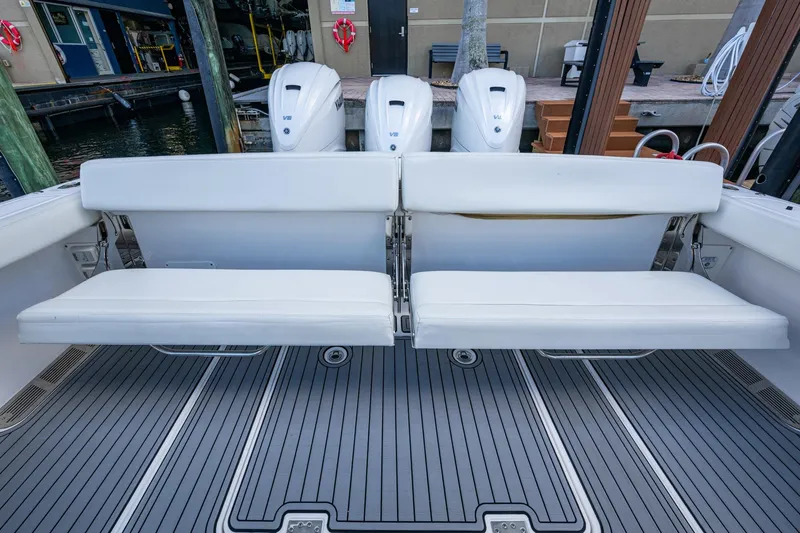  Yacht Photos Pics 2020 Everglades 395 Center Console boat with white seating and triple outboard engines.