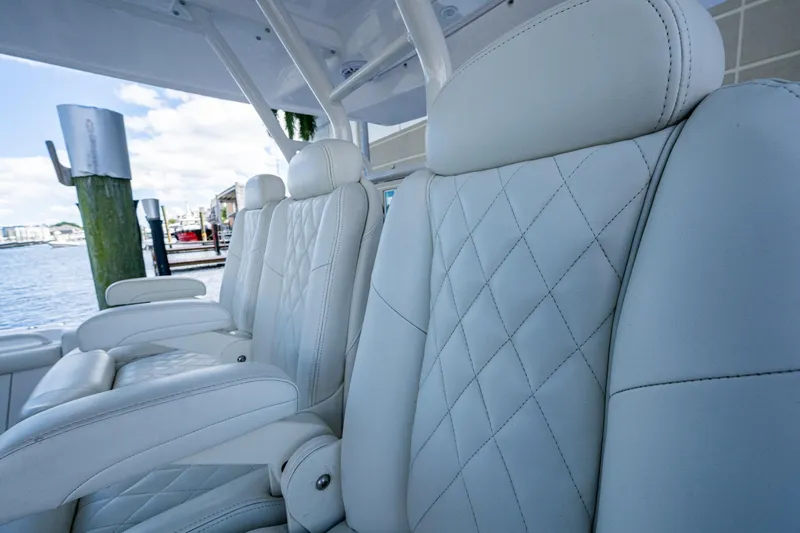  Yacht Photos Pics Luxurious white seating on 2020 Everglades 395 Center Console boat, docked by the water.