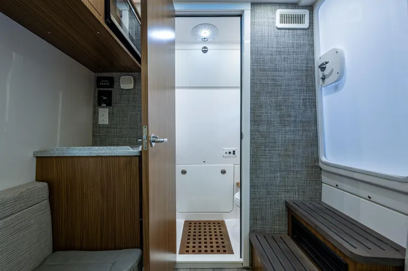 Yacht Photos Pics Interior of 2020 Everglades 395 Center Console boat, featuring a compact bathroom and modern design.