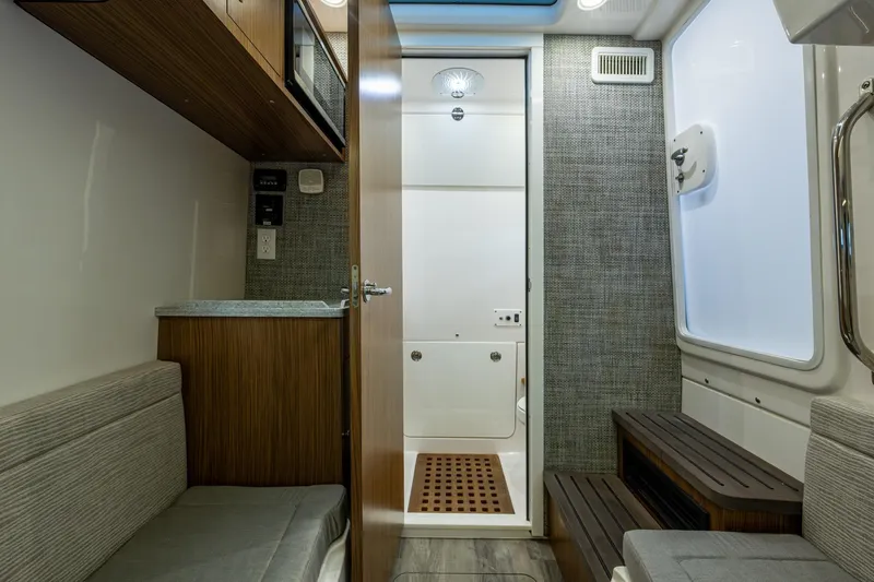  Yacht Photos Pics Interior of 2020 Everglades 395 Center Console boat, featuring modern seating and cabinetry.