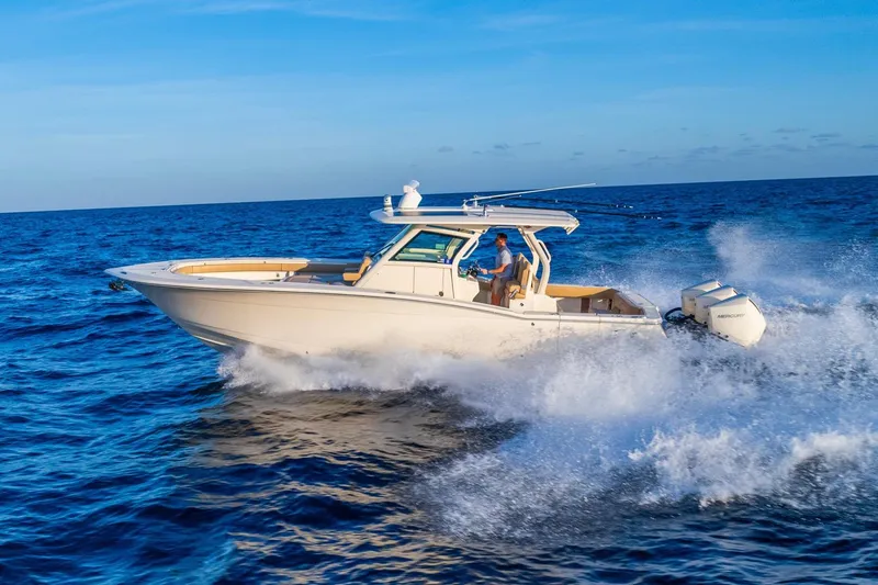  Yacht Photos Pics 2020 Scout 355 LXF boat cruising on open ocean under clear blue sky.