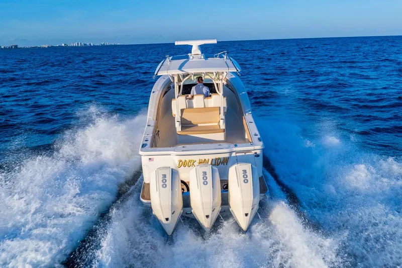  Yacht Photos Pics 2020 Scout 355 LXF boat cruising on open ocean with triple engines.