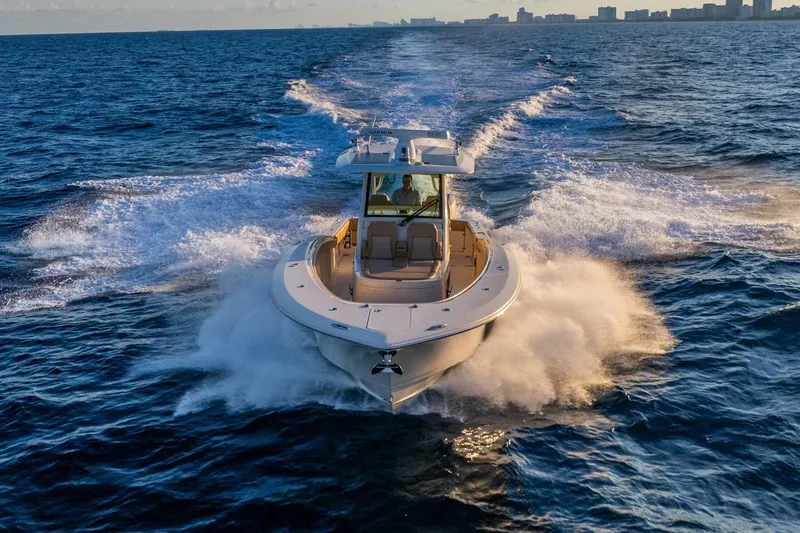  Yacht Photos Pics 2020 Scout 355 LXF boat cruising on open ocean waters.