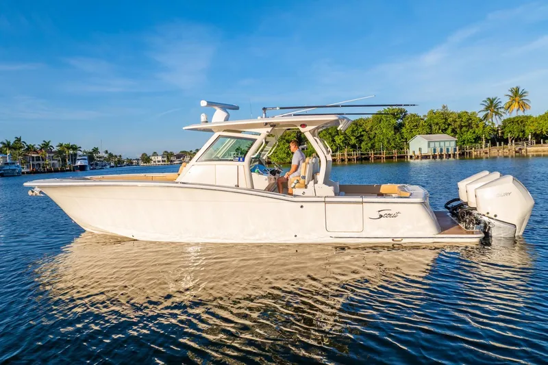  Yacht Photos Pics 2020 Scout 355 LXF boat cruising on a sunny day, featuring sleek design and powerful engines.