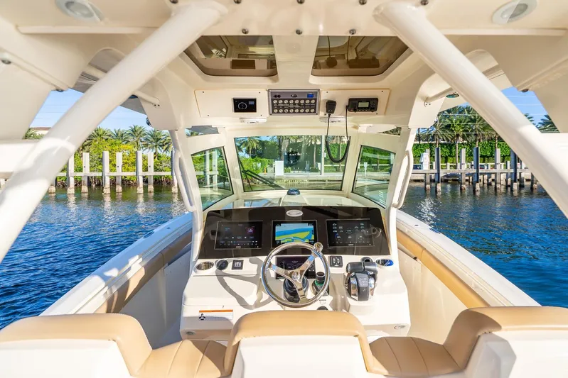  Yacht Photos Pics 2020 Scout 355 LXF boat cockpit with advanced navigation system and luxurious seating.