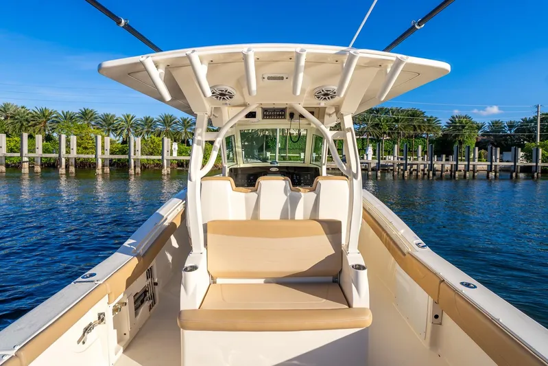  Yacht Photos Pics 2020 Scout 355 LXF boat interior with seating, on a sunny day by the water.