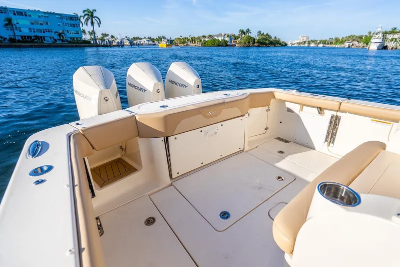  Yacht Photos Pics 2020 Scout 355 LXF boat with Mercury engines on a sunny waterfront.
