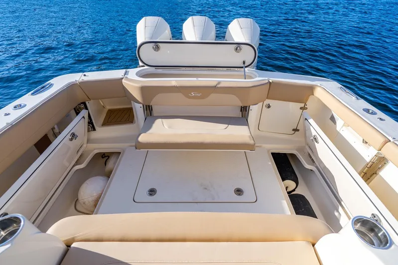  Yacht Photos Pics 2020 Scout 355 LXF boat interior with seating and storage, on blue water.