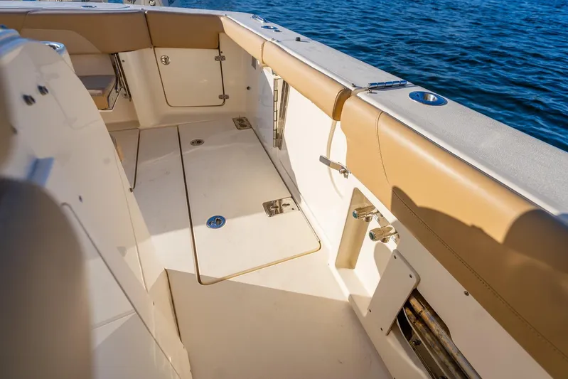  Yacht Photos Pics 2020 Scout 355 LXF boat interior with tan seating and storage compartments.
