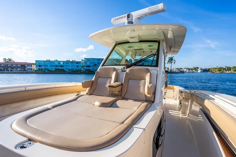  Yacht Photos Pics 2020 Scout 355 LXF luxury boat with comfortable seating, cruising on a sunny day.