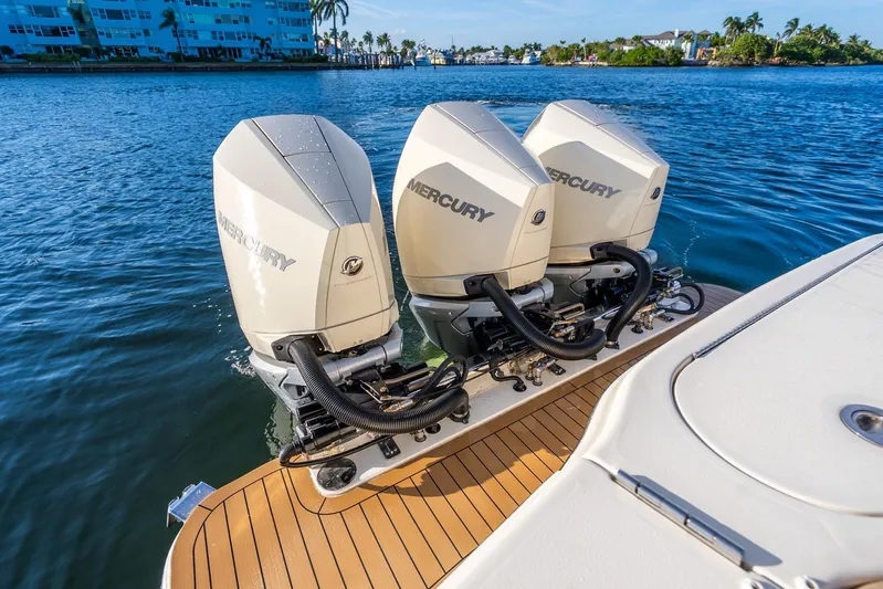  Yacht Photos Pics Triple Mercury outboard engines on 2020 Scout 355 LXF boat, docked on calm water.