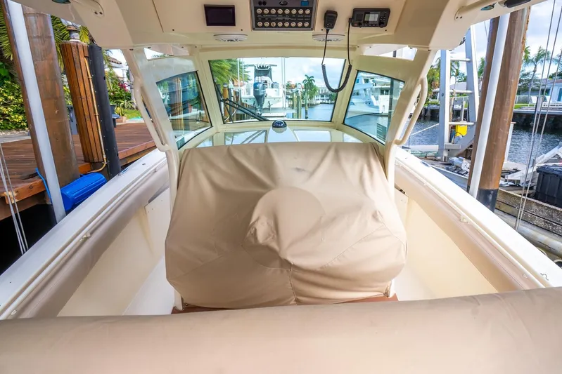  Yacht Photos Pics 2020 Scout 355 LXF boat interior with covered helm station and dock view.